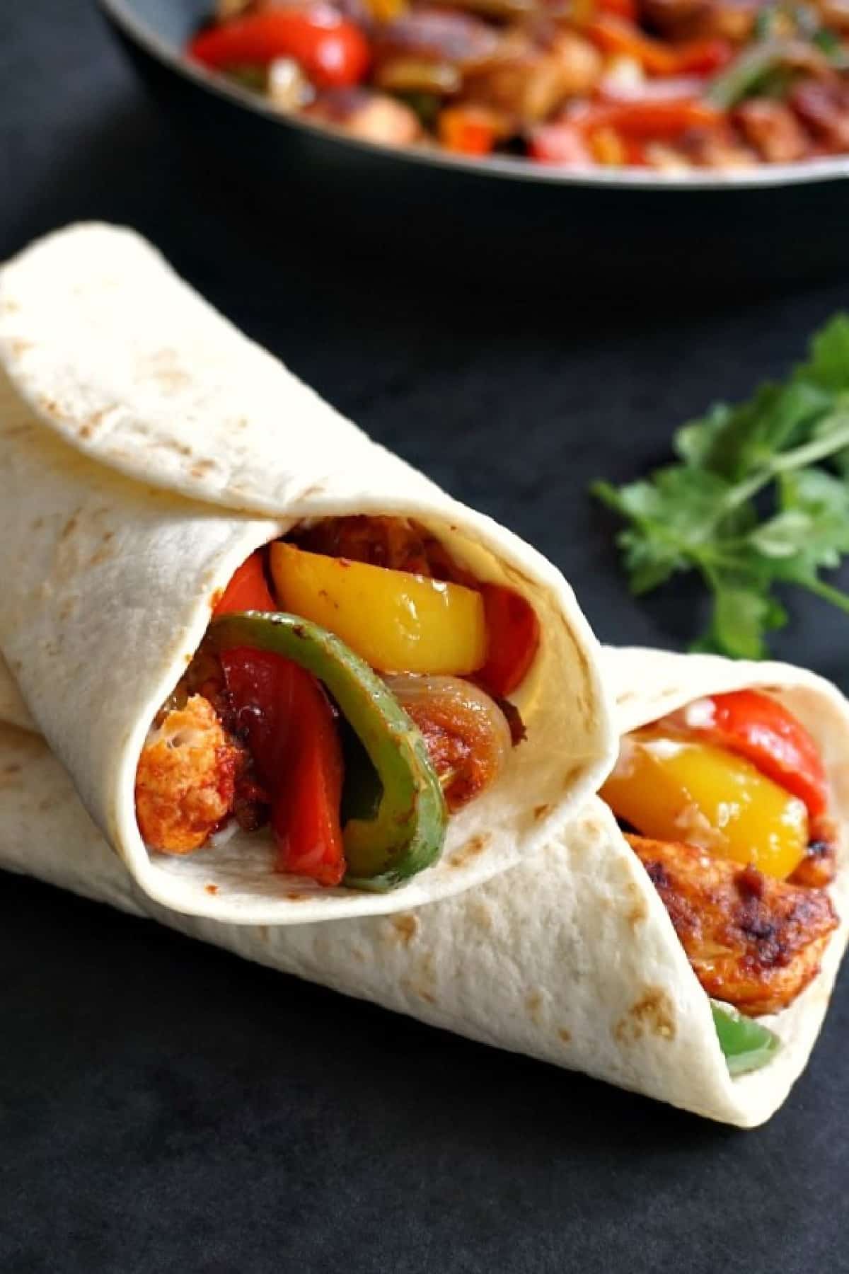 2 wraps with chicken and peppers.