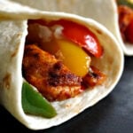 Close-up shoot of a tortilla wrap with chicken fajitas