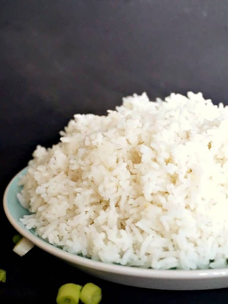 A light blue plate with a pile of basmati rice