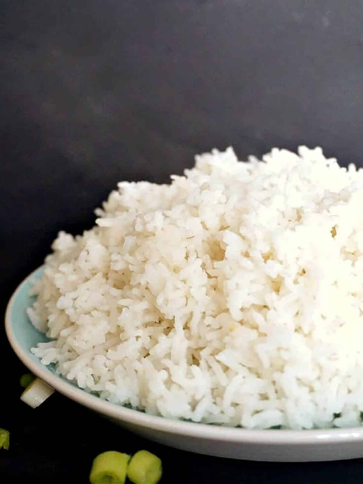 A light blue plate with a pile of basmati rice.