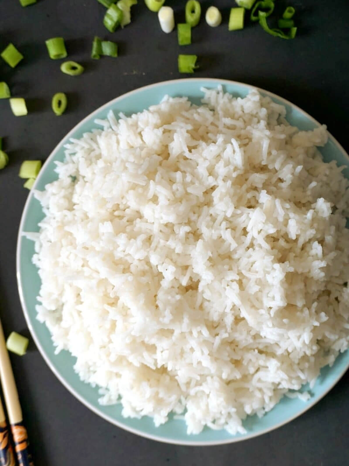 Overhead shoot of a light blue plate with a pile of basmati rice.