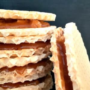 A stack of caramel wafers over a black background