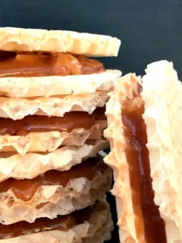 A stack of caramel wafers over a black background