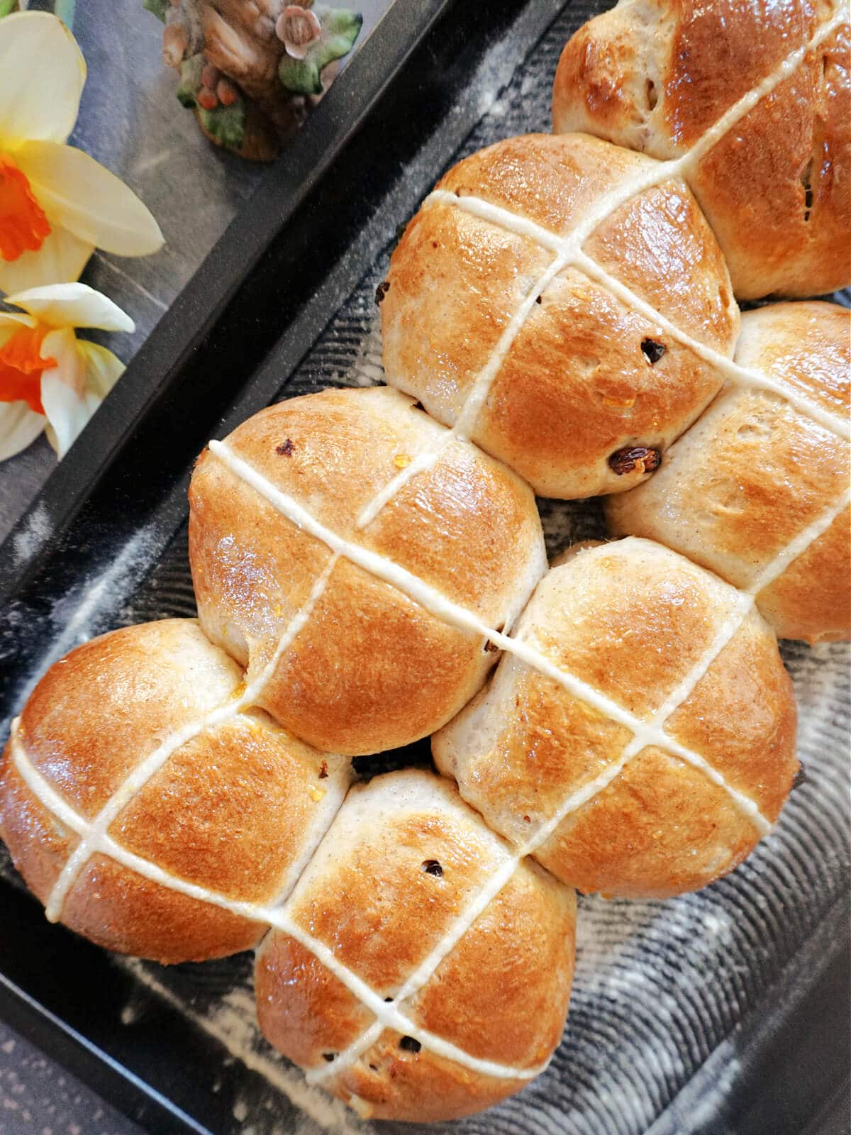 Overhead shot of a tray with 8 hot cross buns.