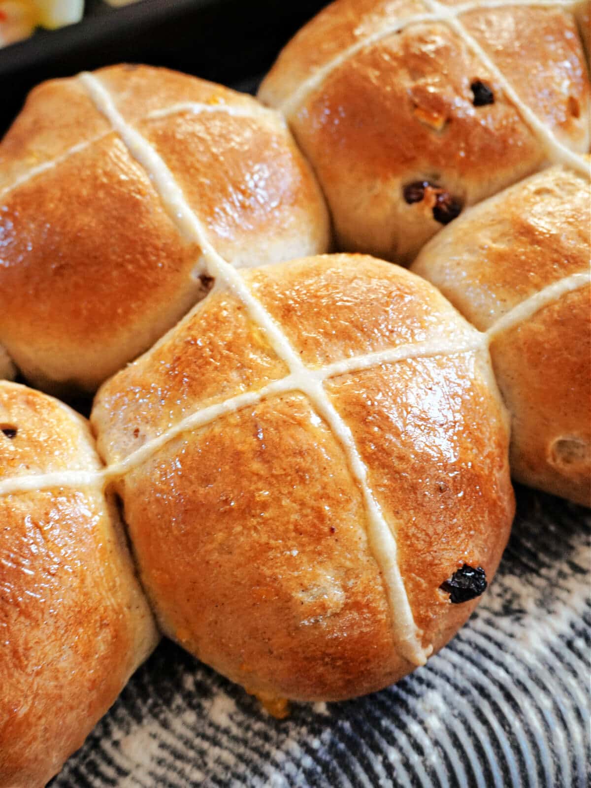 Close-up shot of hot cross buns in a tray.