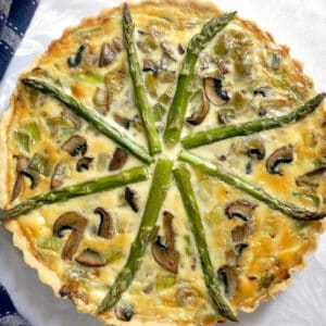 Overhead shoot of a quiche on a white table cloth