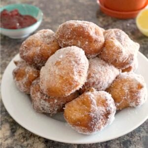 A white plate with beignets