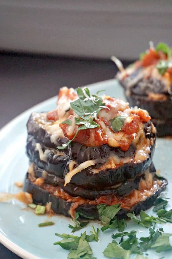 A stack of aubergine slices on a light blue plate