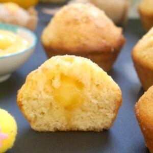 Half of a lemon drizzle muffin to show the lemon curd in the middle