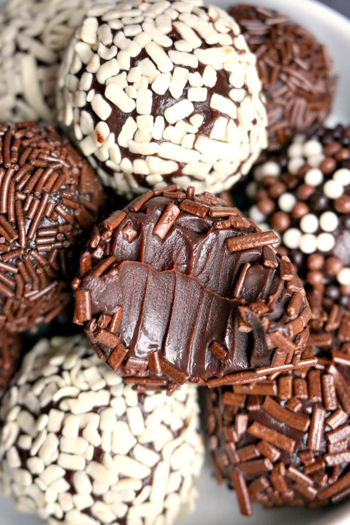 Close-up shot of a half-bitten brigadeiro on top of other brigadeiros