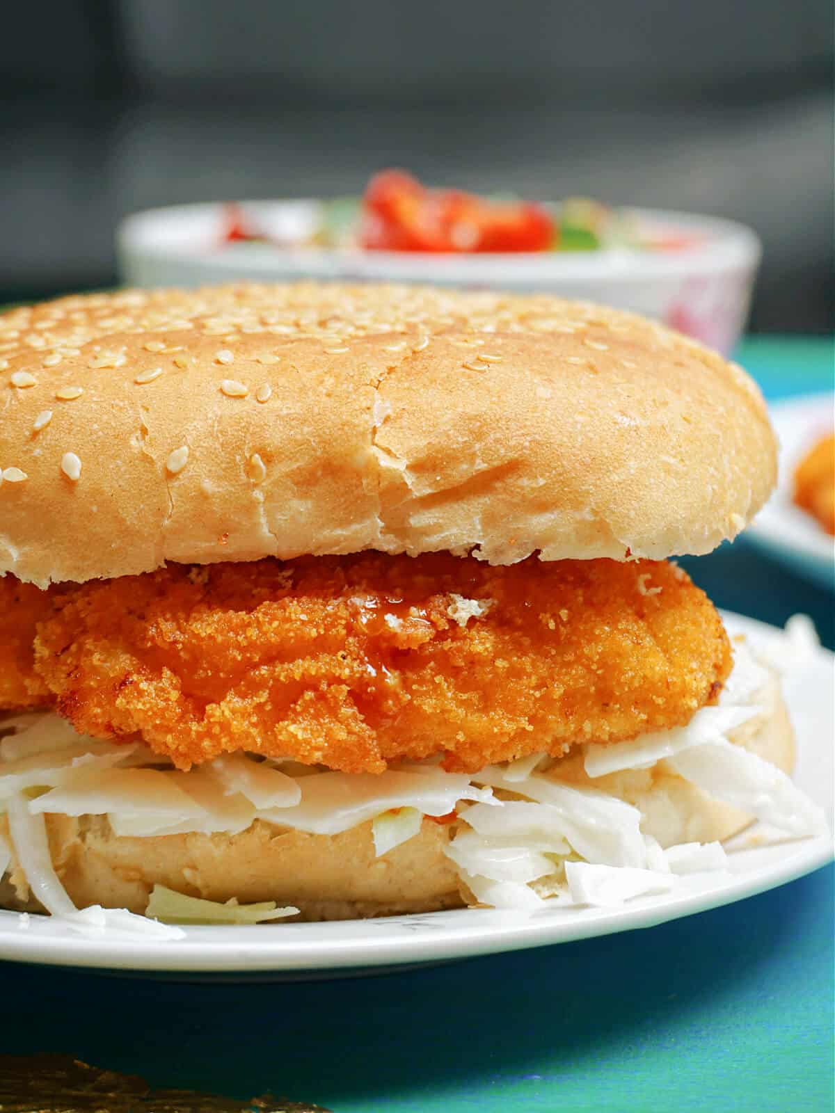 A chicken burger on a white plate
