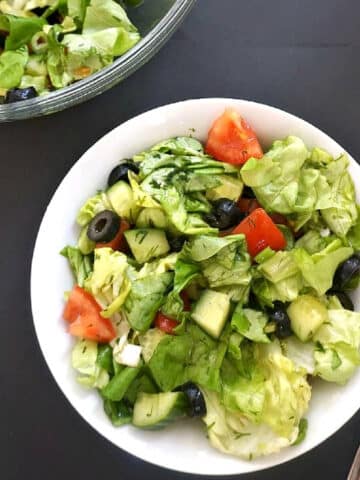 Overhead shoot of a white bowl with green salad