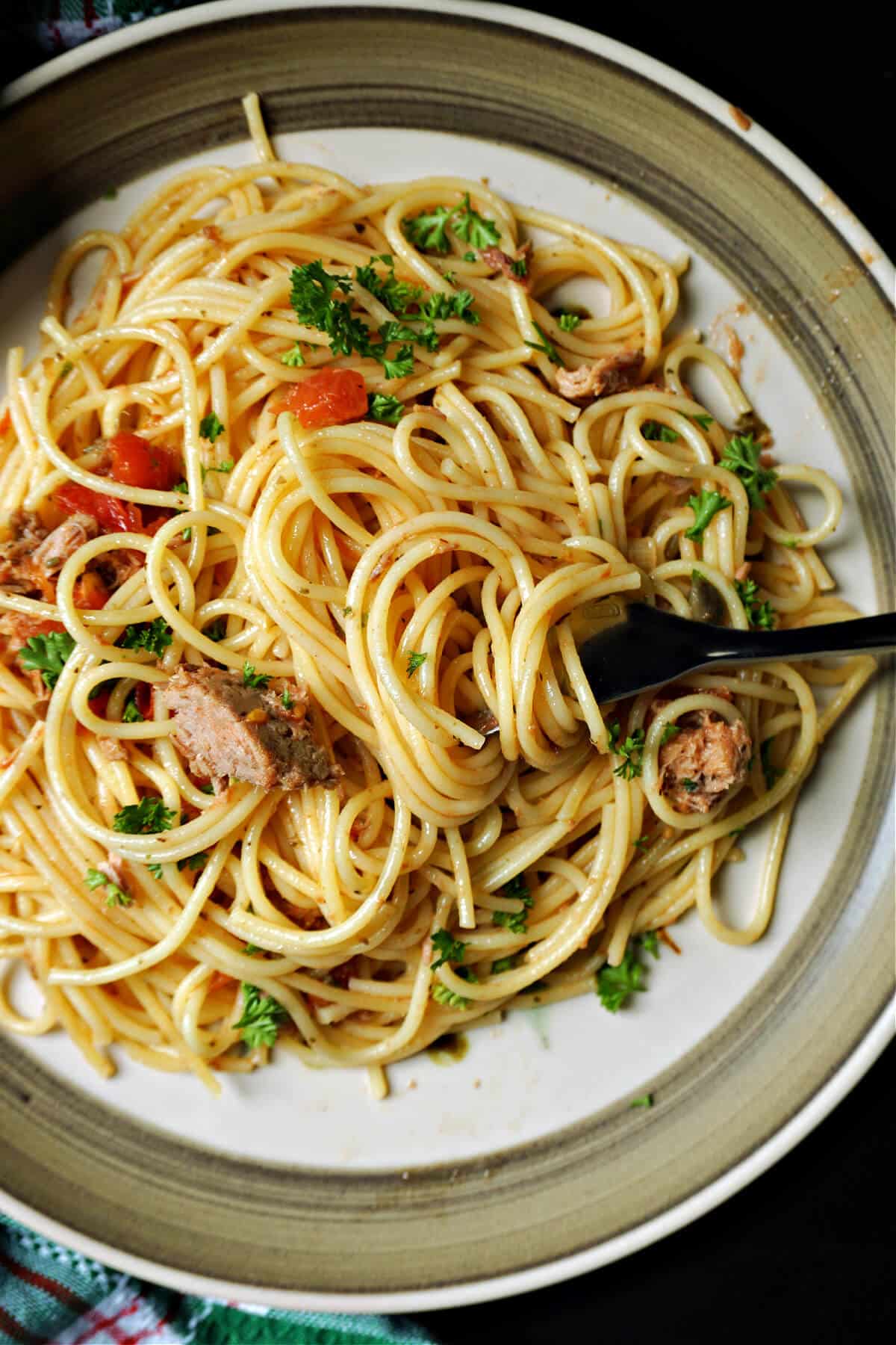 A plate with tuna spaghetti and a fork.