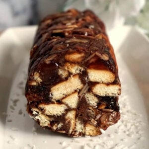 A roll of chocolate salami on a white plate