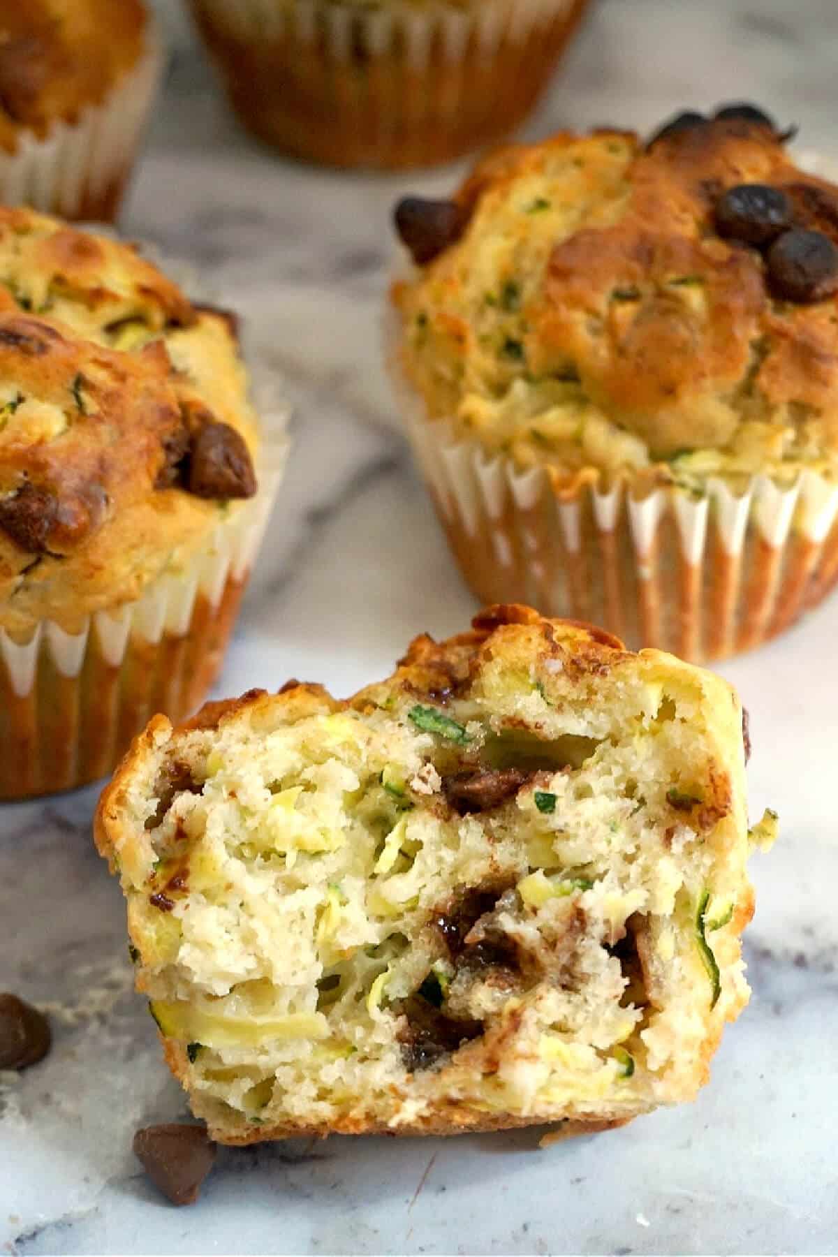 Half of a muffin with 2 whole muffins around it.