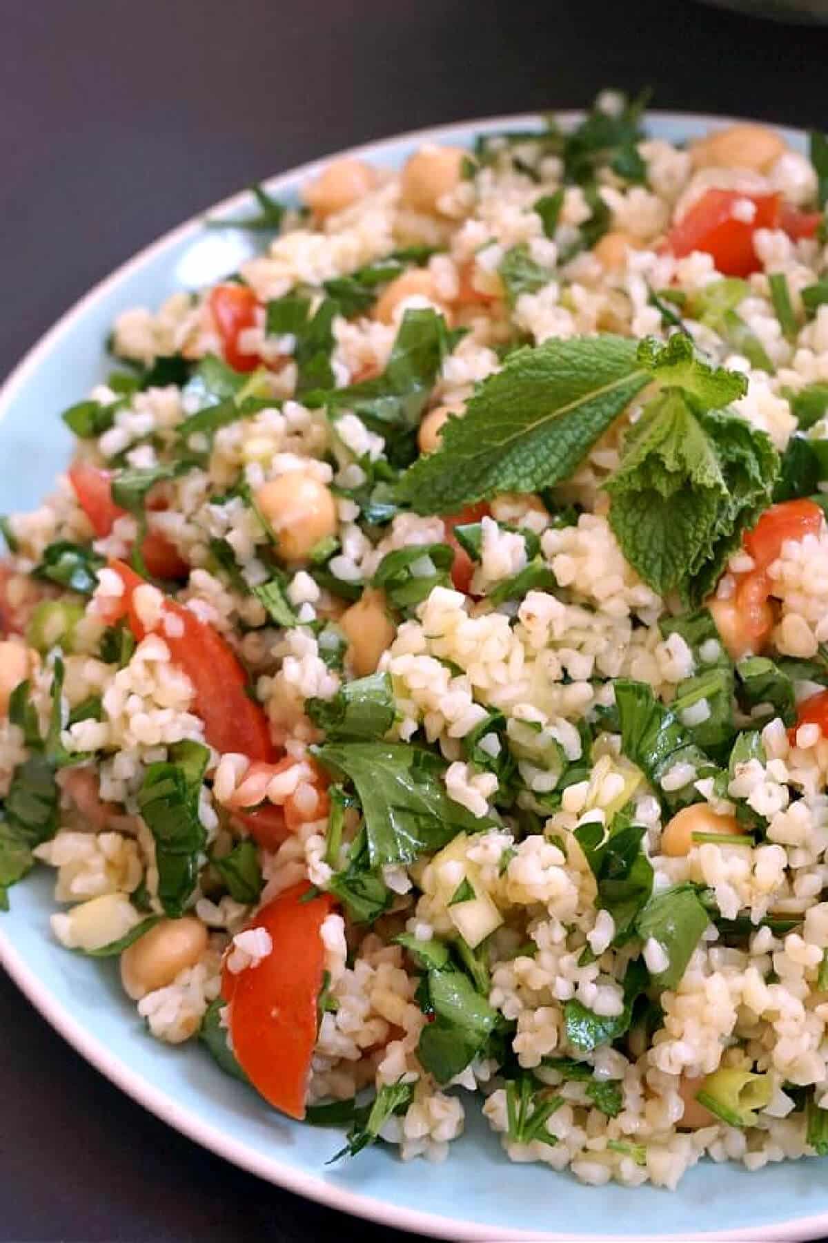 A light blue plate with tabbouleh salad.