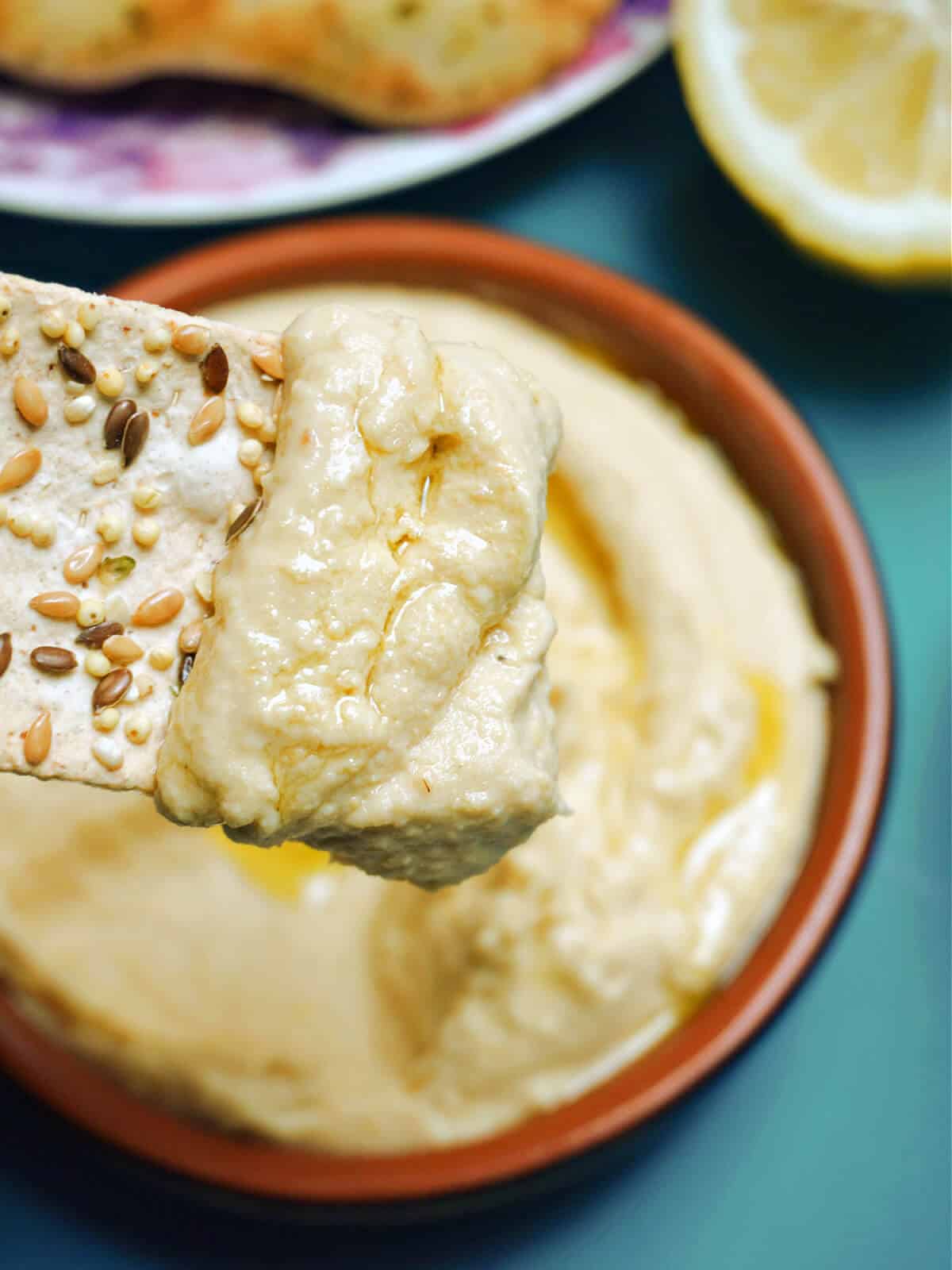 A flatbread dipped into hummus.