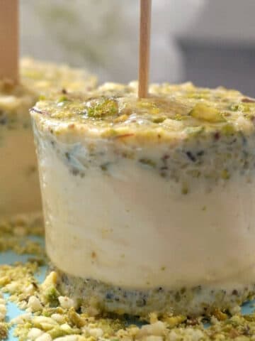 2 kulfi ice cream on a bed of pistachio