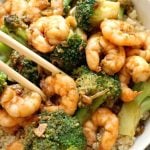 Honey Garlic Shrimp with Broccoli over a bed of rice, a super healthy stir fry that is packed with fantastic flavours. Quick and easy to make, and perfect for a midweek dinner for two, my shrimp stir fry is the best homemade Chinese-style dish you can get. Marinating the shrimp/prawns beforehand enhances the flavours, so not to skip this step. Otherwise, you can get the it ready real quickly in the skillet or even oven. #shrimp, #prawns,#stirfry, #chinesefood, #honeygarlicshrimp, #healthydinner