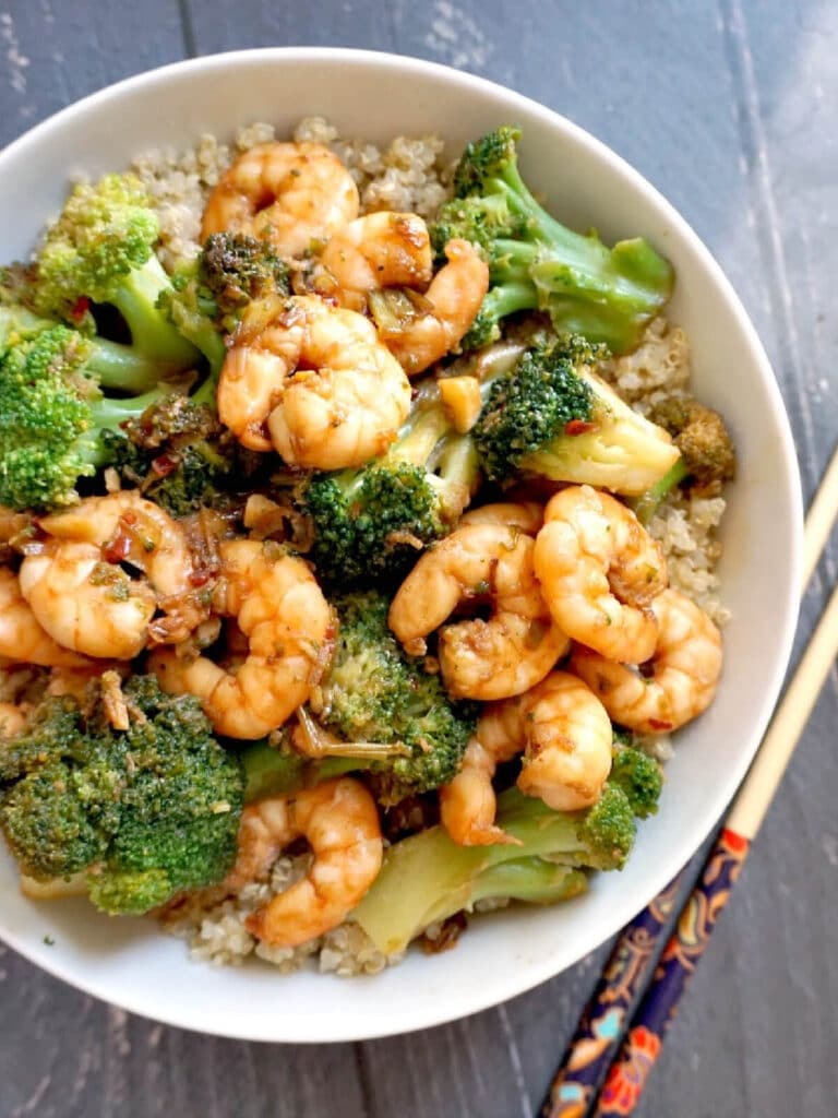 A white bowl with shrimp and broccoli stir fry