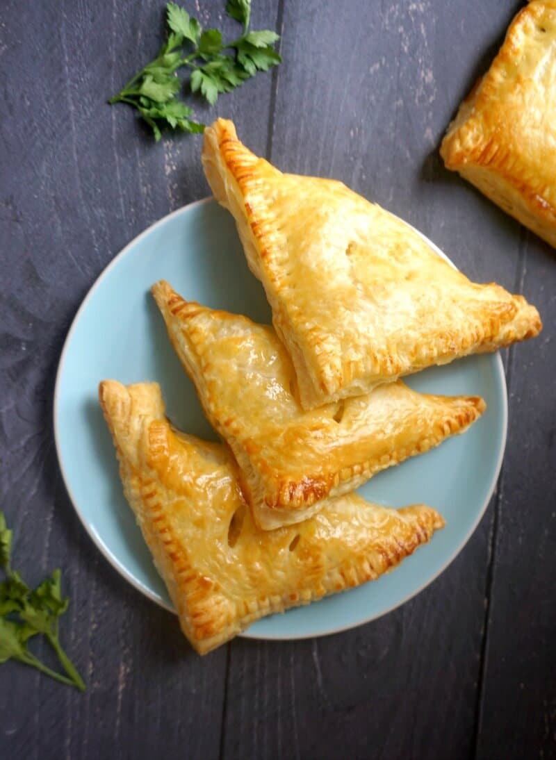 Overhead shoot of a blue plate with 4 turkey hand pies.