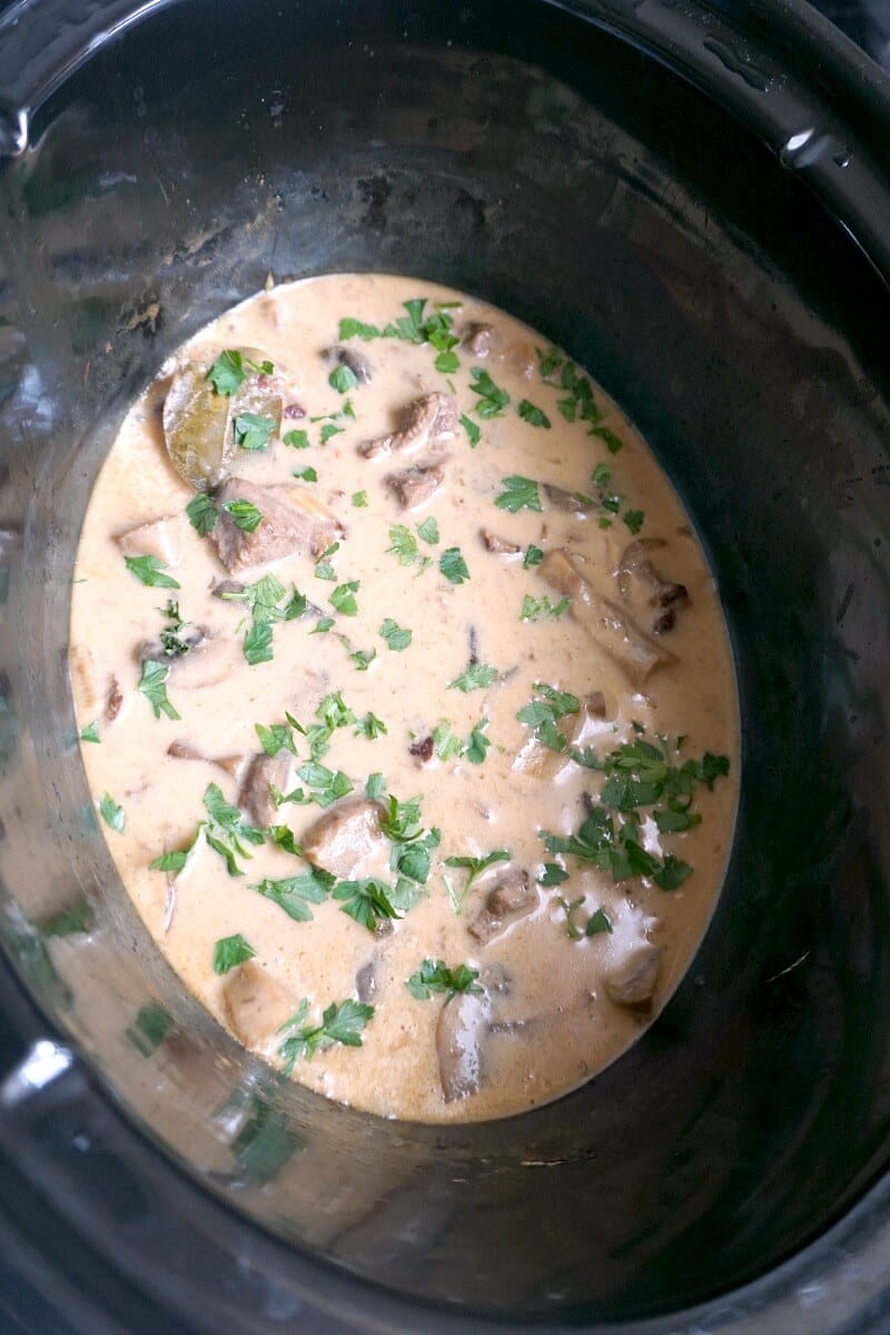 A crock pot with beef stroganoff.