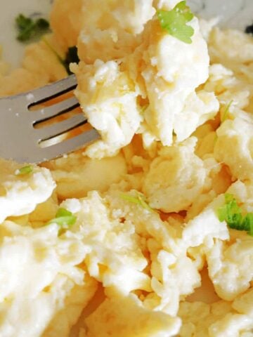 Close-up shot of a plate with scrambled eggs