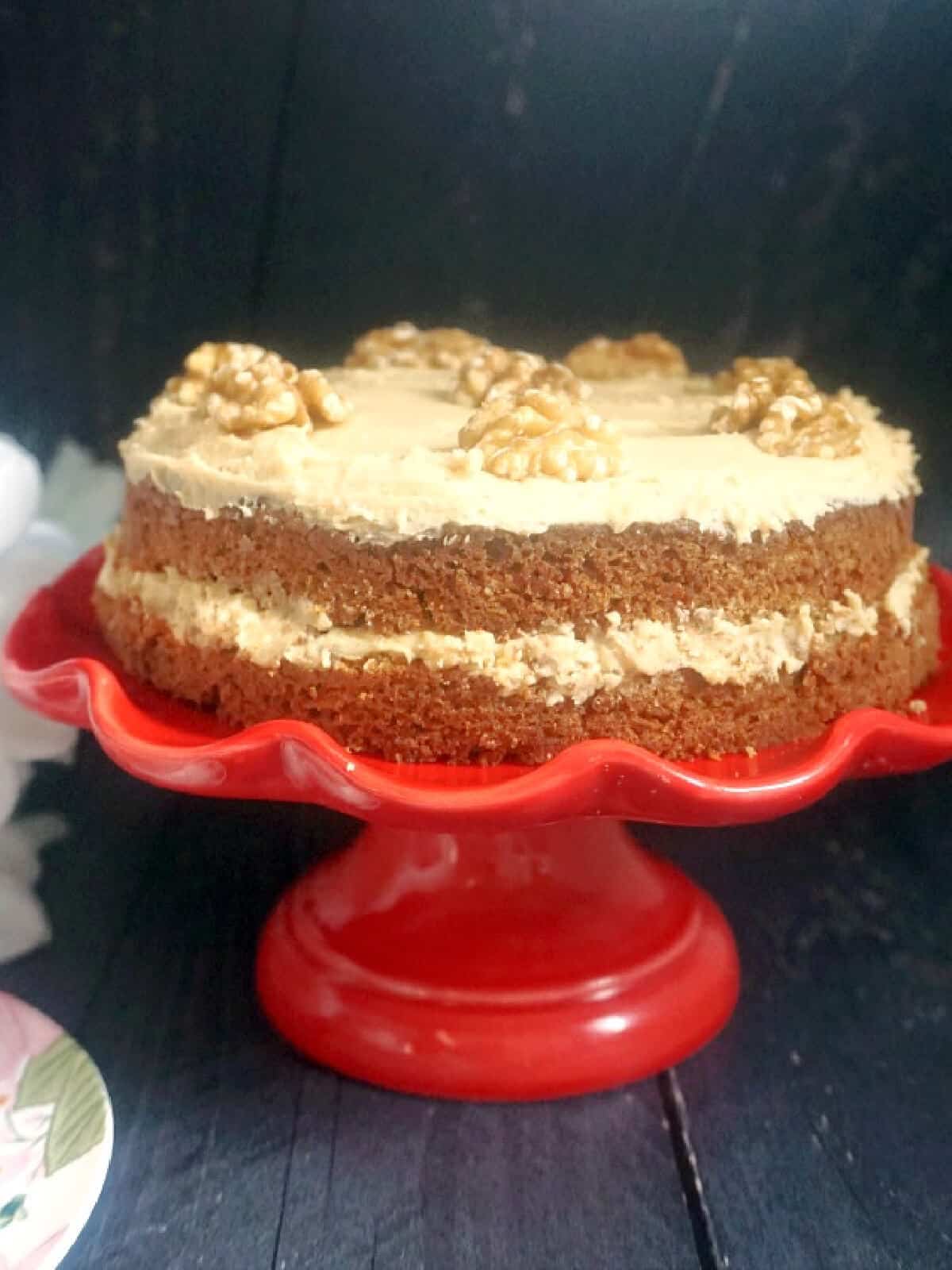 A coffee cake on a red cake stand.