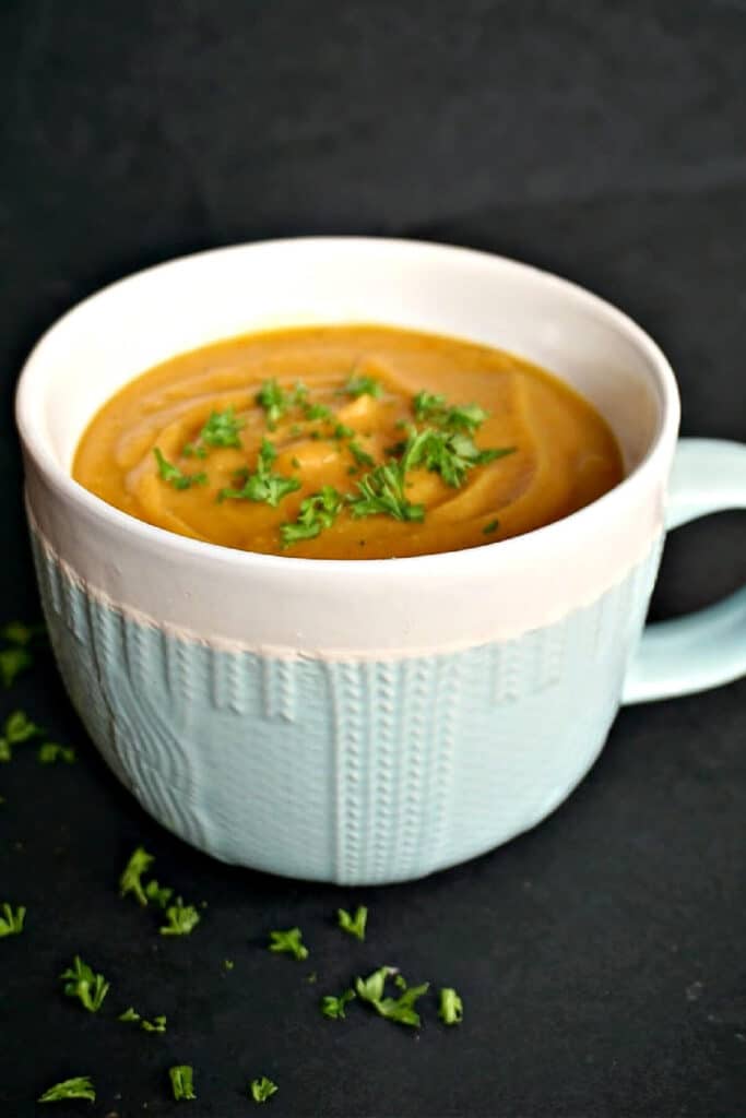 A white and light blue bowl with soup