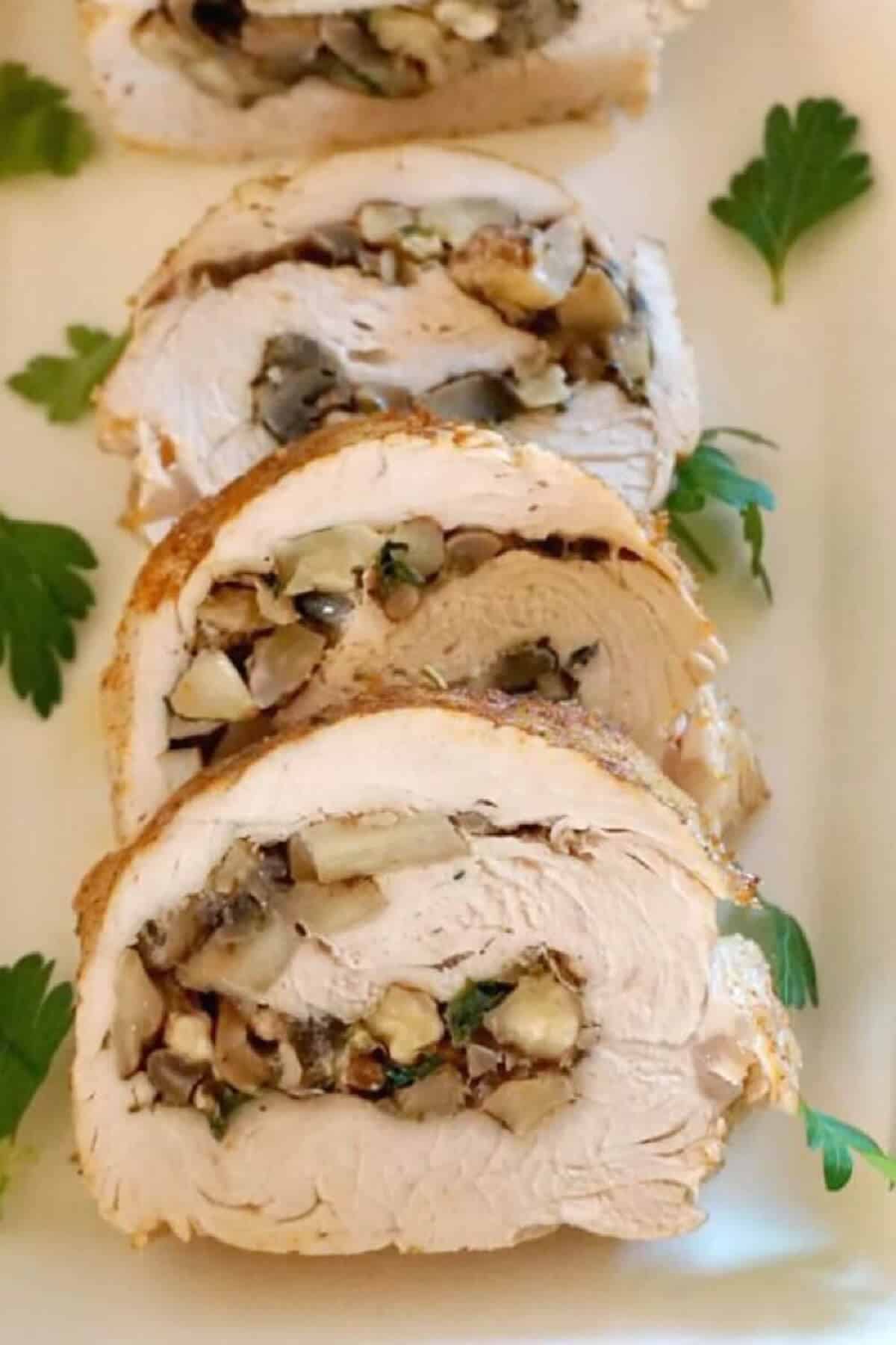 3 turkey rolls on a white plate.