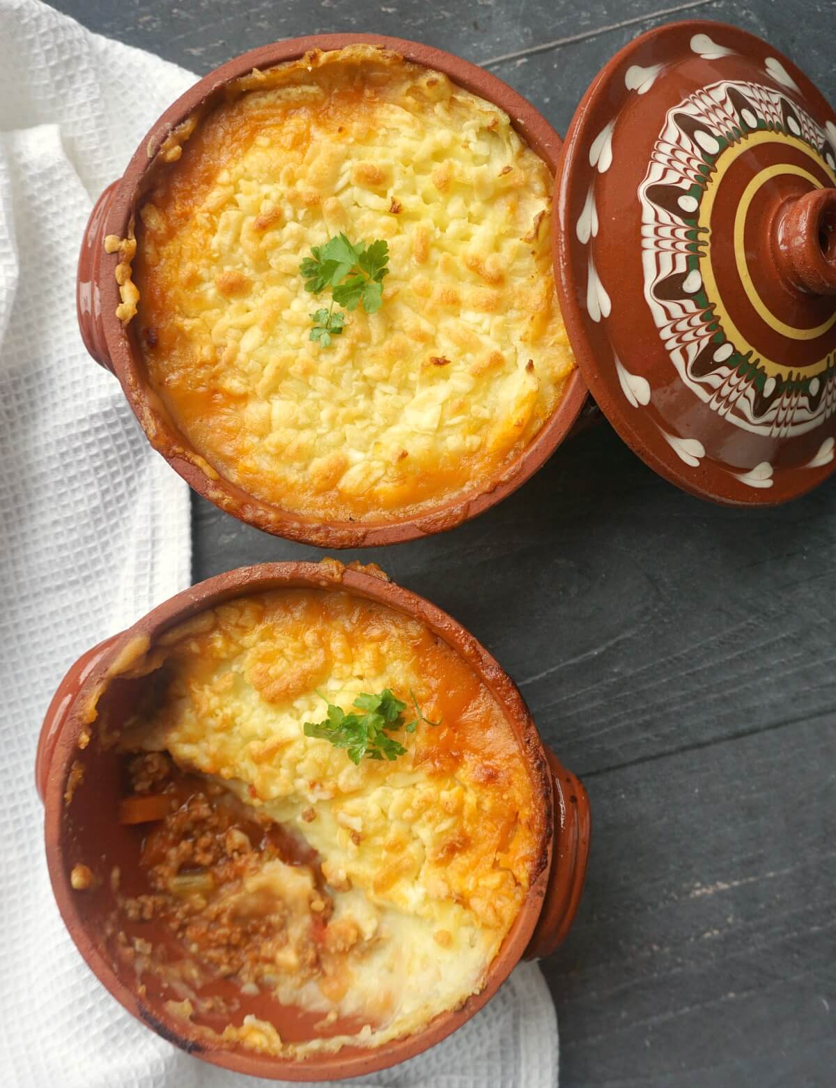 Overhead shoot of 2 pots with cottage pie made with turkey mince.
