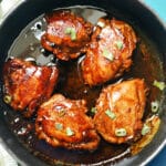 A pan with 5 chicken thighs in adobo sauce