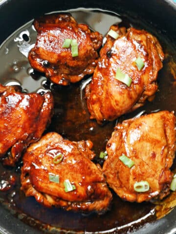 A pan with 5 chicken thighs in adobo sauce