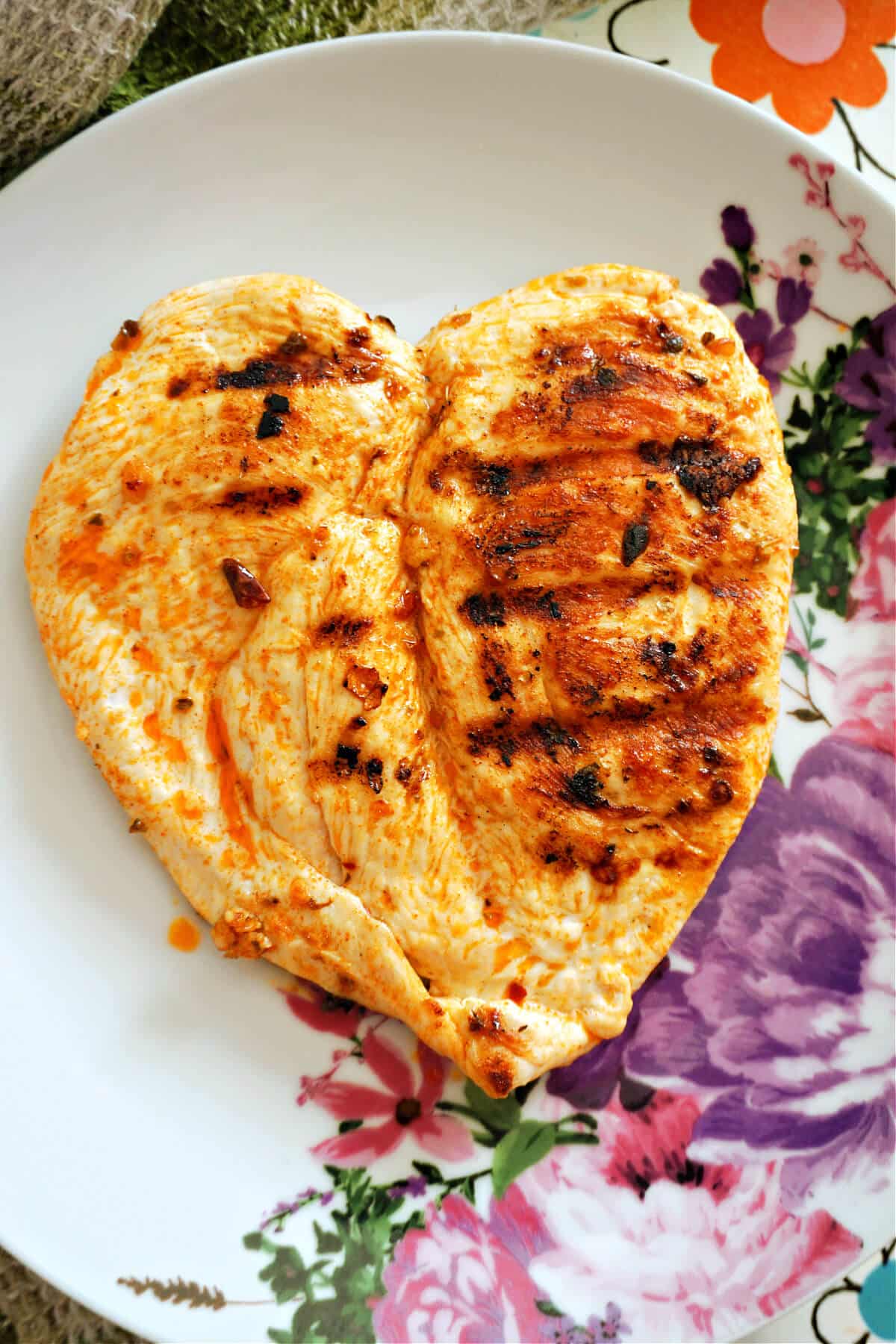 A butterfly chicken breast on a plate.