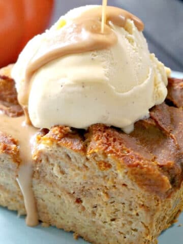 A slice of pumpkin bread pudding topped with ice cream