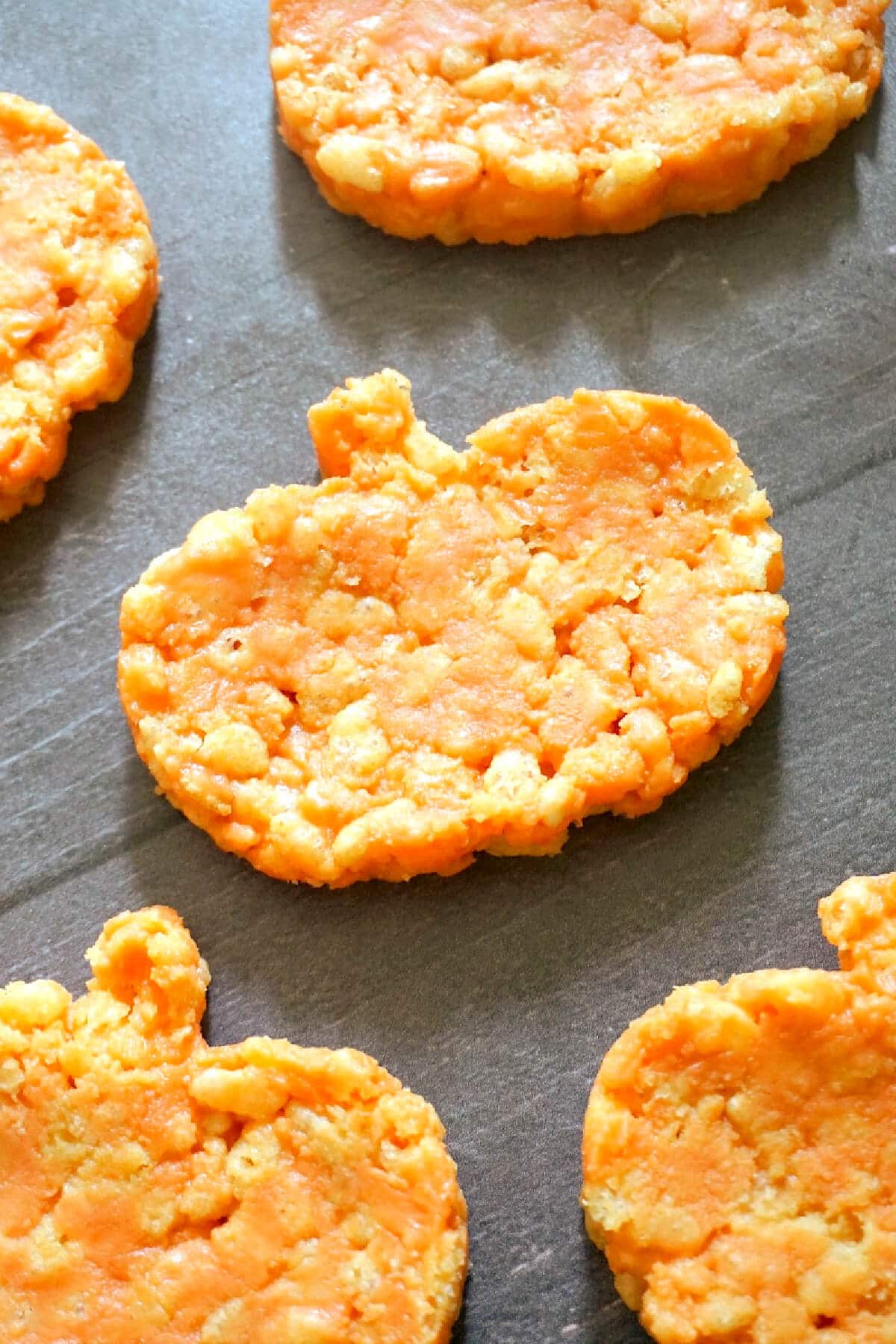 pumpkin-shaped rice krispies on a table top.