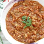 A white bowl with aubergine dip