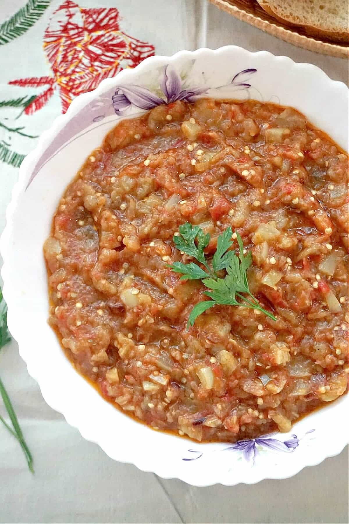 A white plate with aubergine dip.