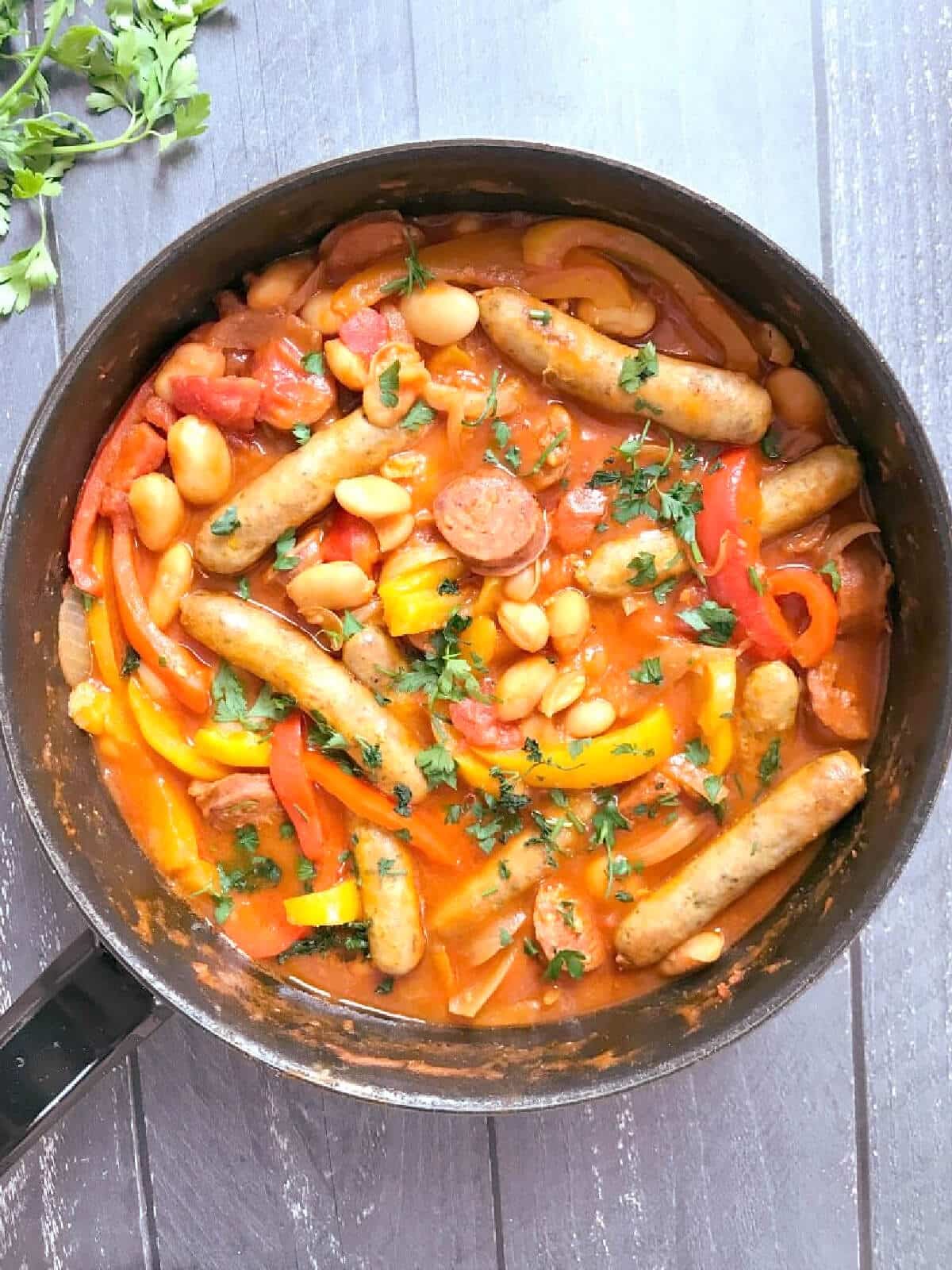 Overhead shoot of a pan with sausage and bean casserole.