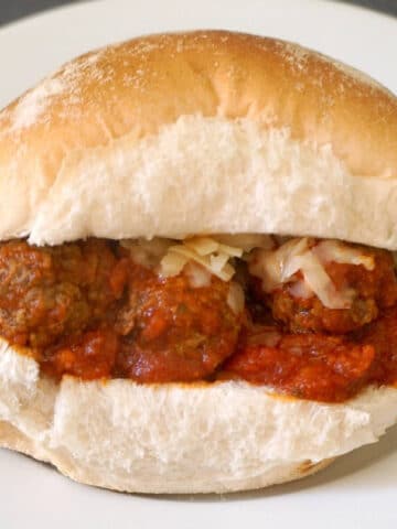 A meatball slider on a white plate