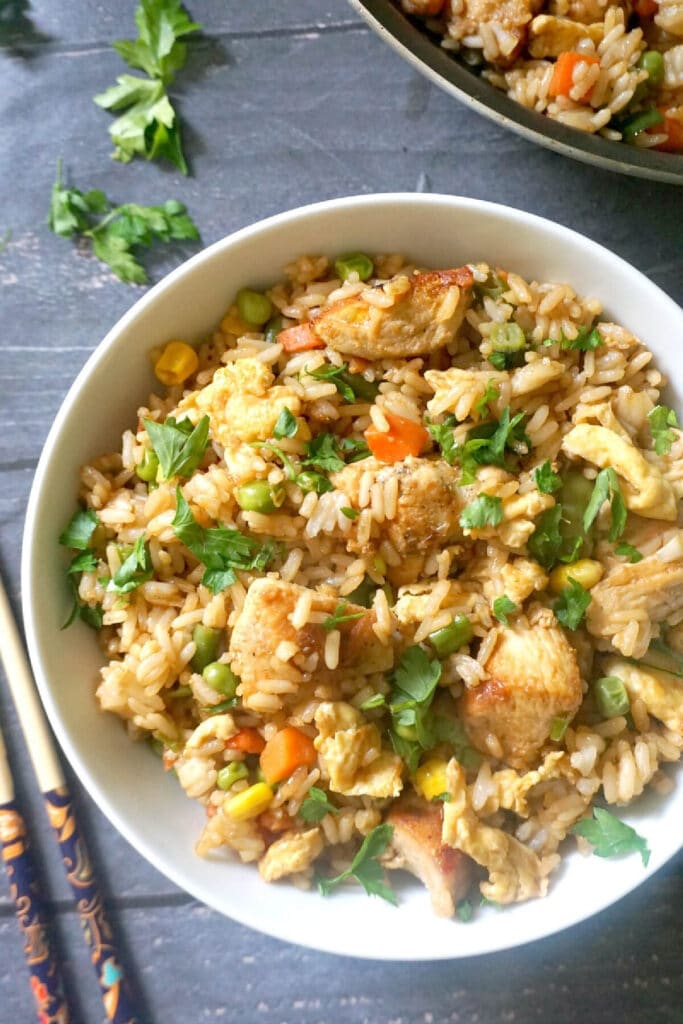 Overhead shoot of a white bowl with chicken egg fried rice