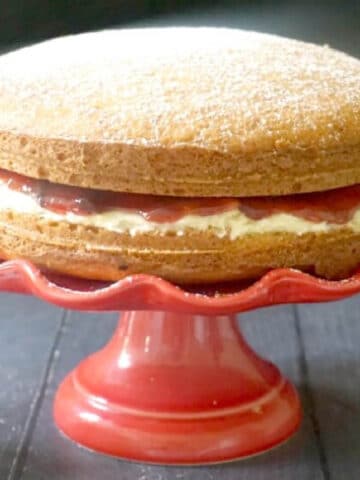 A Sandwich Cake on a red cake stand
