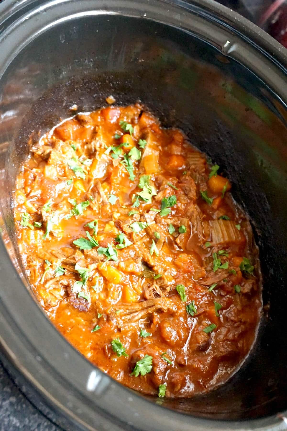 A slow cooker with beef ragu.