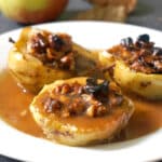 3 baked apple halves on a white plate