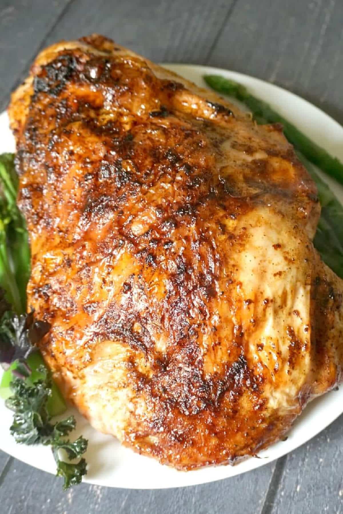 A roast turkey crown on a white plate.