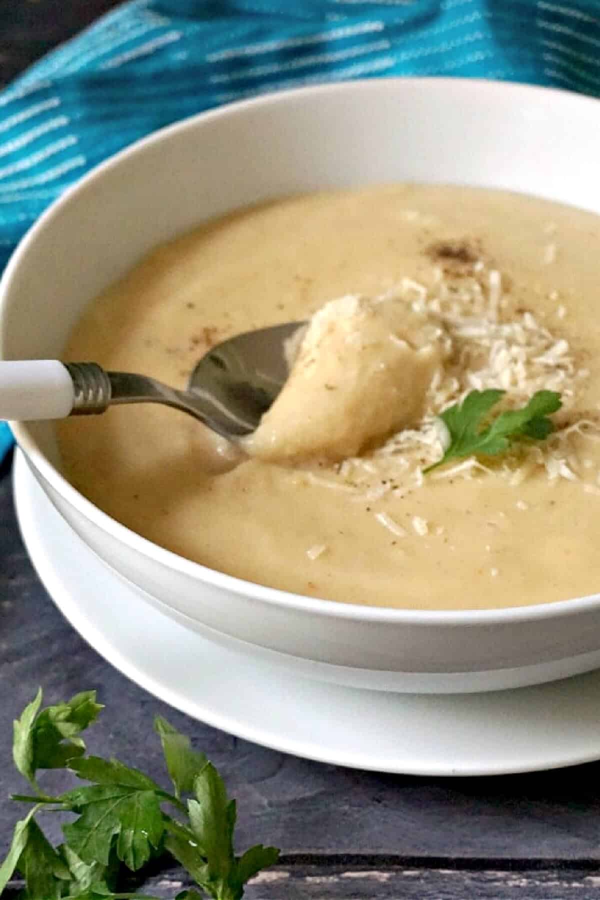 A white bowl with creamy parsnip soup.