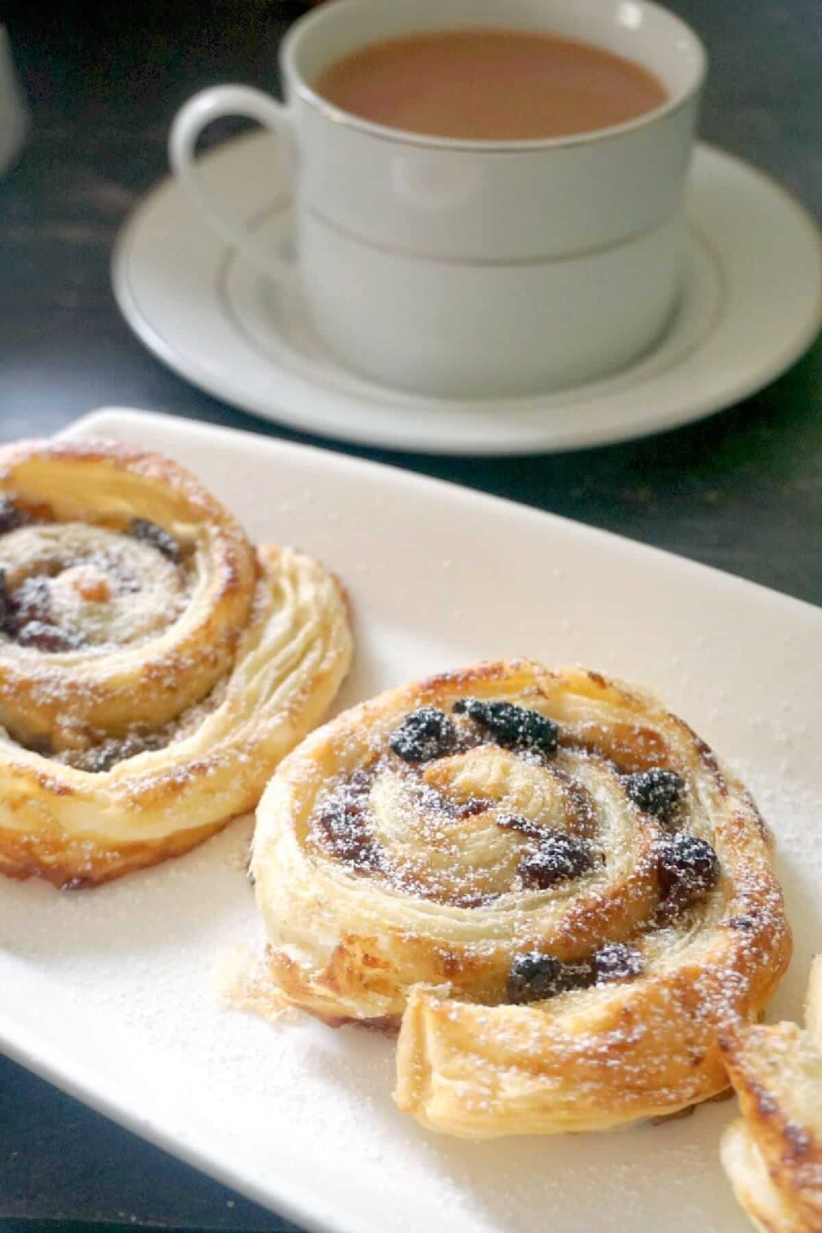 A white rectangle plate with 2 mince pie pinwheels.