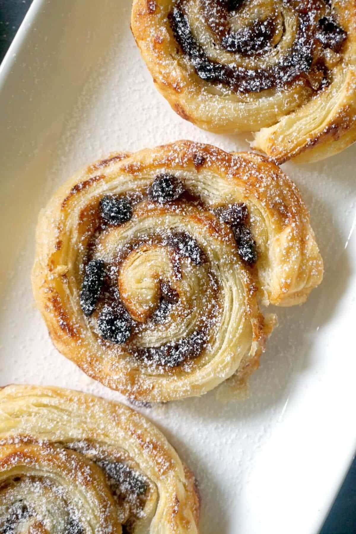 Close-up shoot of a white plate with a mincemeat pinwheel.