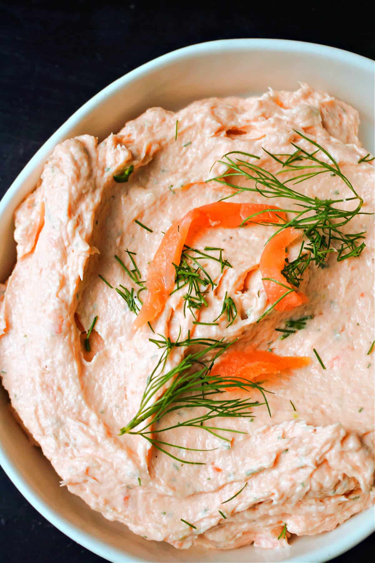 A white bowl with smoked salmon pate.