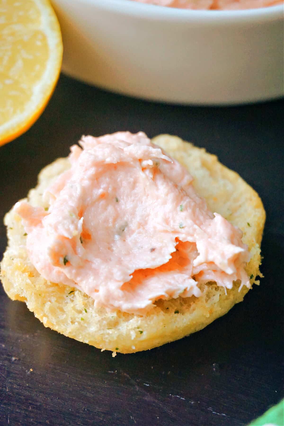 A crostini with smoked salmon pate spread over.